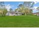 House with lush green lawn and palm tree at 89 Hickory Hills Cir, Ormond Beach, FL 32174