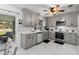 Modern kitchen with gray cabinets, white quartz countertops, and marble flooring at 89 Hickory Hills Cir, Ormond Beach, FL 32174