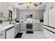 Modern kitchen with gray shaker cabinets, stainless steel appliances, and white quartz countertops at 89 Hickory Hills Cir, Ormond Beach, FL 32174