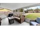 Relaxing screened porch with seating and fire pit at 89 Hickory Hills Cir, Ormond Beach, FL 32174