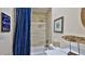 Small bathroom with a tub, shower, and nautical-themed decor at 1453 Sunningdale Ln, Ormond Beach, FL 32174