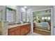 Main bathroom features a double vanity, granite countertops, and a view of the bedroom at 1453 Sunningdale Ln, Ormond Beach, FL 32174