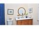 Bathroom with a single vanity, a round mirror, and a blue shower curtain at 1453 Sunningdale Ln, Ormond Beach, FL 32174