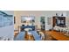 Bright dining room with blue table, and view to the living room at 1453 Sunningdale Ln, Ormond Beach, FL 32174