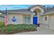 Front view of a house with blue door and nautical decor at 1453 Sunningdale Ln, Ormond Beach, FL 32174