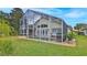 Back exterior view of the house with a screened pool area at 1453 Sunningdale Ln, Ormond Beach, FL 32174