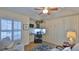 Home office with built-in cabinetry, desk, and comfortable seating area at 1453 Sunningdale Ln, Ormond Beach, FL 32174