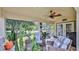 Spacious screened porch with wicker furniture and serene view at 1453 Sunningdale Ln, Ormond Beach, FL 32174