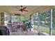 Relaxing screened porch with wicker furniture and ceiling fan, overlooking backyard at 1453 Sunningdale Ln, Ormond Beach, FL 32174