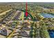 Aerial view showing a house nestled in a community near a pond at 1510 Kinnard Cir, Ormond Beach, FL 32174