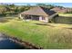 Aerial view of home showcasing backyard and pond at 1510 Kinnard Cir, Ormond Beach, FL 32174