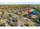 Aerial view of a house and neighborhood, showing a pond and tennis court nearby at 1510 Kinnard Cir, Ormond Beach, FL 32174