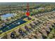 Aerial view of a house in a community by a pond and other houses at 1510 Kinnard Cir, Ormond Beach, FL 32174