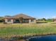 House featuring a pond and backyard view at 1510 Kinnard Cir, Ormond Beach, FL 32174