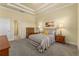 Spacious bedroom with striped bedding and wood furniture at 1510 Kinnard Cir, Ormond Beach, FL 32174