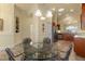 Bright dining room with glass table and view of kitchen at 1510 Kinnard Cir, Ormond Beach, FL 32174