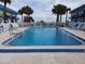 Inviting community pool with surrounding lounge chairs at 2750 Ocean Shore Blvd # 4, Ormond Beach, FL 32176