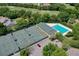 Aerial view of community pool, tennis courts, and surrounding landscape at 3238 Bailey Ann Dr, Ormond Beach, FL 32174