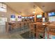 Long bar with seating and multiple TV screens at 3238 Bailey Ann Dr, Ormond Beach, FL 32174