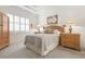 Spacious bedroom with wood furniture, neutral decor, and large windows at 3238 Bailey Ann Dr, Ormond Beach, FL 32174