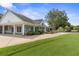 Exterior view of a white clubhouse with a large porch at 3238 Bailey Ann Dr, Ormond Beach, FL 32174