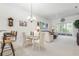 Bright dining area with glass table, chandelier, and adjacent living space at 3238 Bailey Ann Dr, Ormond Beach, FL 32174