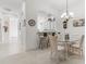 Dining room with glass table, chandelier, and kitchen views at 3238 Bailey Ann Dr, Ormond Beach, FL 32174