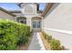 Front entry with walkway, shrubs, and neutral-colored siding at 3238 Bailey Ann Dr, Ormond Beach, FL 32174