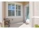 Front entry with two chairs, frosted glass door, and white shutters at 3238 Bailey Ann Dr, Ormond Beach, FL 32174