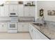 Bright eat-in kitchen with white cabinets, granite countertops, and stainless steel appliances at 3238 Bailey Ann Dr, Ormond Beach, FL 32174