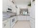 Open concept kitchen with white cabinets, granite counters & stainless steel appliances at 3238 Bailey Ann Dr, Ormond Beach, FL 32174