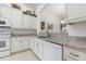 Modern kitchen featuring white cabinetry, granite countertops, and a breakfast bar at 3238 Bailey Ann Dr, Ormond Beach, FL 32174