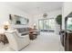 Spacious living room with sectional sofa, large TV, and access to patio at 3238 Bailey Ann Dr, Ormond Beach, FL 32174