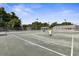 Tennis courts with ball cart and seating at 3238 Bailey Ann Dr, Ormond Beach, FL 32174