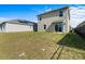 Large backyard with grassy area and home view at 447 Liu Ln, Deland, FL 32724