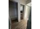Hallway with shelving, utility closet, and wood-look floors at 5500 Ocean Shore Blvd # Ut61, Ormond Beach, FL 32176