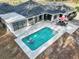 Aerial view of a residence with a pristine pool and an expansive entertainment area at 7024 Sw 93Rd Street Rd, Ocala, FL 34476