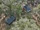 Aerial view of a cozy home surrounded by lush trees, along with a separate outbuilding at 7024 Sw 93Rd Street Rd, Ocala, FL 34476