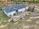 Aerial view of a home with a large wooden deck perfect for enjoying the outdoors, and a trampoline at 7024 Sw 93Rd Street Rd, Ocala, FL 34476