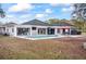 An inviting backyard features a modern pool, outdoor seating, and a partially covered lounge area at 7024 Sw 93Rd Street Rd, Ocala, FL 34476