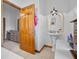 This bathroom showcases a pedestal sink, arched mirror, and natural wood accents at 7024 Sw 93Rd Street Rd, Ocala, FL 34476