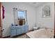 The bathroom features a blue vanity with a large soaking tub and a serene window view at 7024 Sw 93Rd Street Rd, Ocala, FL 34476