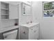 Clean bathroom with white cabinets, a functional mirror, and a window at 7024 Sw 93Rd Street Rd, Ocala, FL 34476