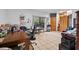This bedroom offers neutral tile flooring, desk area, and bright window at 7024 Sw 93Rd Street Rd, Ocala, FL 34476