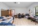 Bedroom boasts neutral tile flooring, a window, and desk area at 7024 Sw 93Rd Street Rd, Ocala, FL 34476