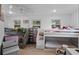 Bright bedroom with bunk beds, storage shelves, and multiple windows at 7024 Sw 93Rd Street Rd, Ocala, FL 34476