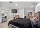 Large bedroom featuring neutral tile flooring, natural light and a comfortable bed at 7024 Sw 93Rd Street Rd, Ocala, FL 34476