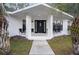 Inviting front porch with seating and a decorative front door, perfect for relaxing at 7024 Sw 93Rd Street Rd, Ocala, FL 34476