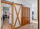 Hallway featuring wood sliding barn door and closet storage at 7024 Sw 93Rd Street Rd, Ocala, FL 34476
