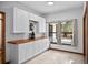 Bright kitchen area featuring white cabinets and butcher block countertops at 7024 Sw 93Rd Street Rd, Ocala, FL 34476